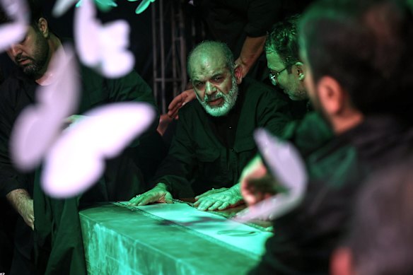 General Ahmad Vahidi sits alongside Khamenei’s casket in a mourning hall adjacent to mosque.