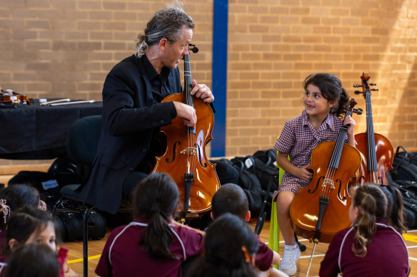 Australian Chamber Orchestra cellist Julian Thompson with year 2 student Selena Ayad.