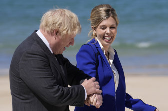 British Prime Minister Boris Johnson and his wife Carrie walk on the boardwalk during G7 on June 12 in St Ives, England.  In a post on Instagram, Carrie Johnson has said she feels “incredibly blessed to be pregnant again”, expecting the couple’s second child. 
