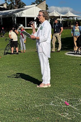Sue Bremner speaking beside a GIICA bore marker.