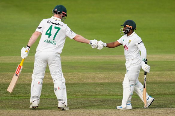 South Africa’s Simon Harmer pumps his fist with captain Temba Bavuma.