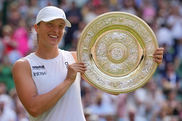 Poland’s Iga Swiatek holds the trophy after beating Amanda Anisimova to win the women’s singles final.
