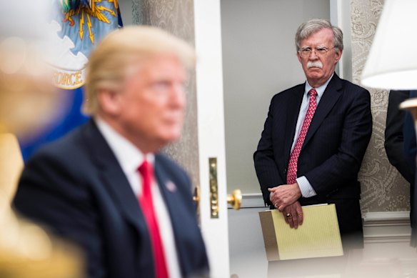 Bolton listens to Trump speaks at the White House in 2018.