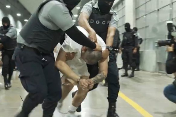 A man identified by Jennifer Vasquez Sura as her husband, Kilmar Abrego Garcia, is led by force by guards through the Terrorism Confinement Centre in Tecoluca, El Salvador in an undated photo.