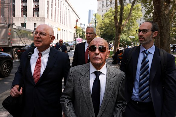 Joe Lewis, centre, leaving court in 2023 after appearing on insider trading charges for which he was convicted.