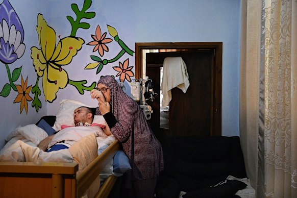 Najah al-Rajabi and her grandson Awad Nasser al-Rajabi in the family home in the Batn al-Hawa neighbourhood of Silwan, East Jerusalem.