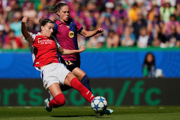 Arsenal’s Steph Catley, front, duels with Barcelona’s Ewa Pajor.