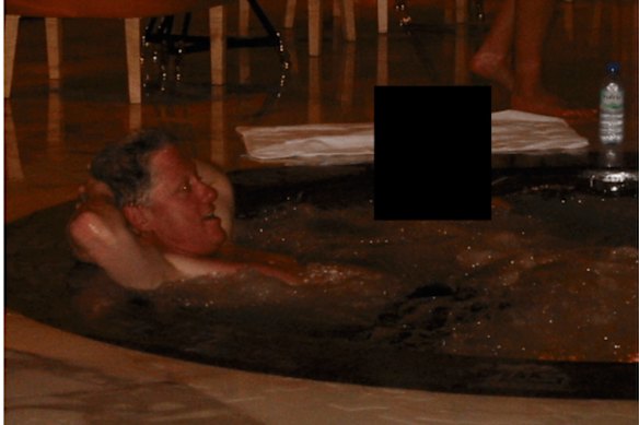 Bill Clinton in a hot tub with an unknown person.