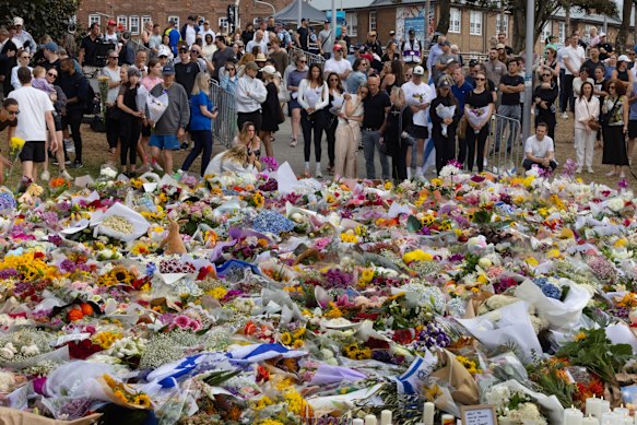 People gather at Bondi Beach on December 16 to pay their respects to those who lost their lives and to the families affected by the massacre.