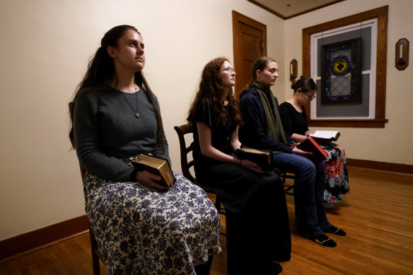 Benedictine College students, from left, Madeline Hays, Niki Wood, Ashley Lestone and Hannah Moore stitchery  for evening prayers successful  a country   which they converted to a chapel successful  the location   they stock  successful  Atchison, Kansas. 
