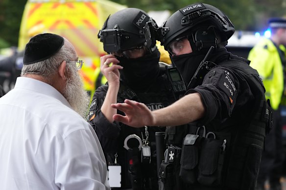 Members of the public and congregants seen as Police and other emergency responders attend the Heaton Park Hebrew Congregation Synagogue.