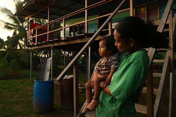 Garia Ken, 24, at home in Papa with one-year-old son Varnon, who will receive a second round of polio vaccinations this month. 