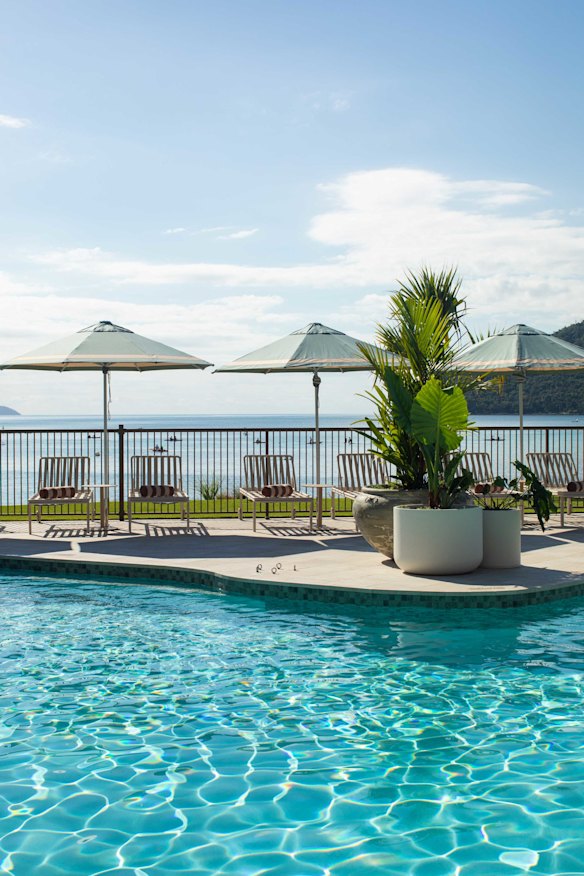 Dining settings and daybeds poolside provide ample spots for guests to enjoy a cocktail.