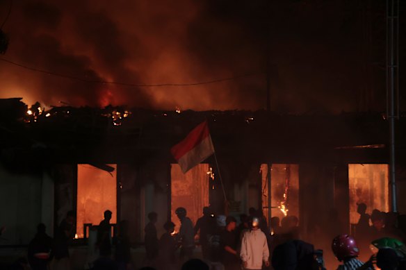 Flames engulf the official residence of the East Java governor in Surabaya on Saturday.