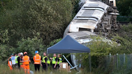 Carriages of a derailed train on their side near the town of Lewes, in southern England, on Thursday.