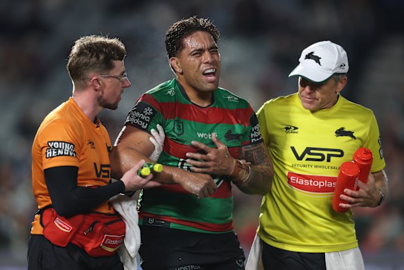 Tevita Tatola is helped from the field after dislocating his shoulder.