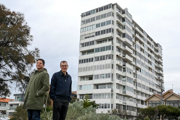 Architect Rowan Opat and homeowner Russell Jessop stand in front of the 64-year-old Edgewater Towers in St Kilda.