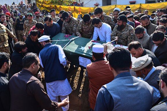 Relatives and soldiers carry the coffin of an army officer killed in a suicide bombing in the border district of Bannu on February 22.