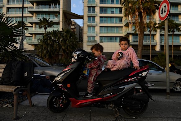 Ali and Baloul, whose home in Laylaki was destroyed in an airstrike last Monday, play on a scooter on the footpath of the Corniche.