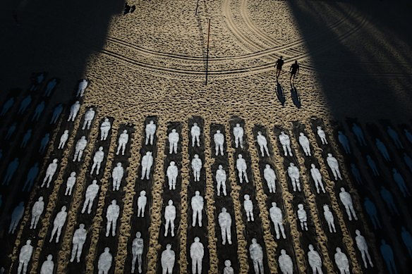 People walk past an installation marking the third anniversary of the October 7, 2023, Hamas-led attack on Israel, on the beachfront in Tel Aviv, Israel.