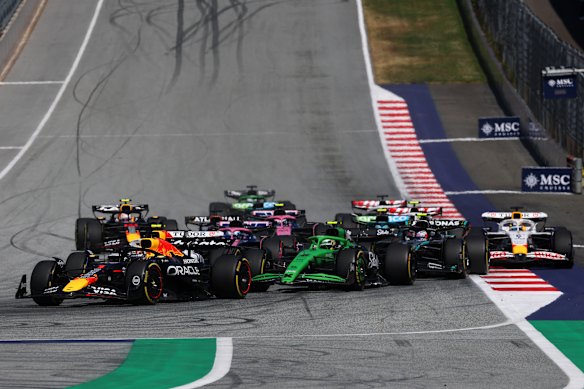 Action from the opening lap of the race – moments before Max Verstappen (far left) crashed out.