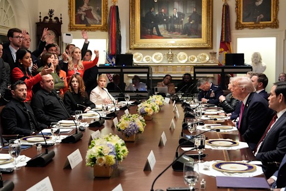 Trump, second right, and Zelensky, seated left, take questions from reporters before a lunch at the White House on Friday.