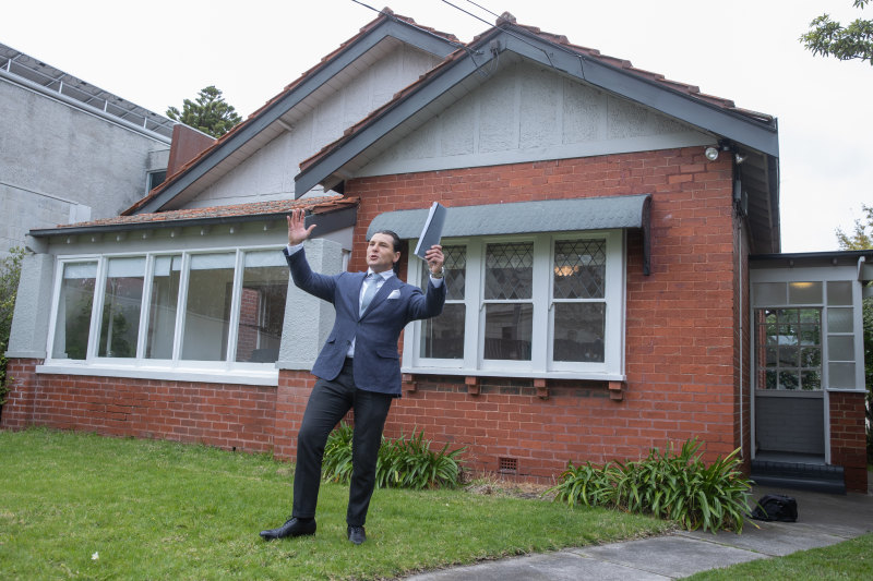 Marshall White Bayside auctioneer Matthew Pillios asks for bids at 84 Carpenter Street, Brighton on Saturday.