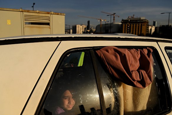 Nazzal&rsquo;s 11-year-old daughter Fatima sits in a car that has been lent to her family so they have some shelter.