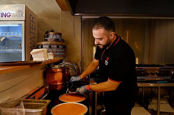 Mohammad Ismail makes the first batch of Palestinian nabulsi knafeh for customers of his stall at Lakemba Nights during Ramadan.