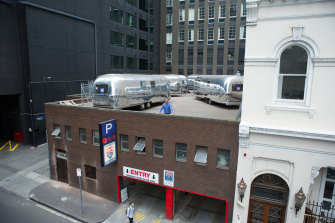 Owner James Fry at his Flinders Lane parking space, which hosts six Airstream trailers as a rooftop hotel.