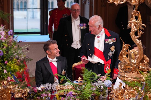 Macron looks on as King Charles speaks during the banquet.