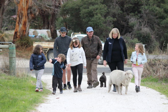 Archer with her family on their 2000-hectare cattle and sheep farm. From left: Molly, James, Luke, Lauren, husband Winston and Edith, accompanied by poodle Roxy and hand-raised pet sheep Barry.