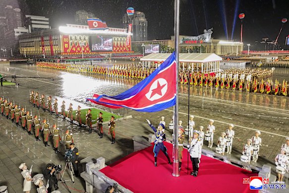 Troops line the square as the North Korean flag is raised at the Pyongyang parade.