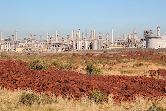 The scattered rock art of Murujuga, with Woodside’s Karratha plant in the background.