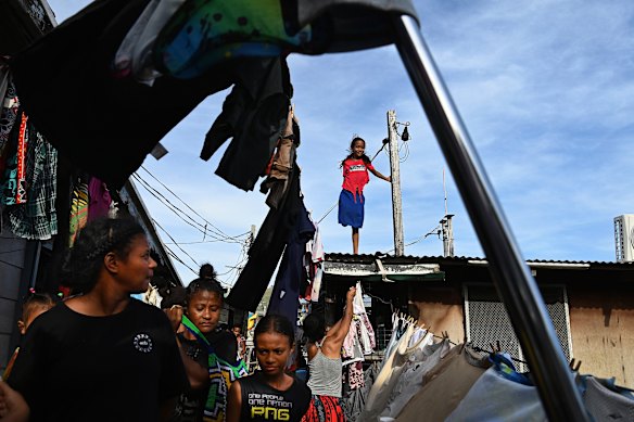 A girl stands on the roof of one of the many houses on stilts in Wanigela village, Port Moresby, where its 3000 residents have no access to drinking water. Proper sanitation and hygiene is crucial to preventing the spread of viruses such as polio.