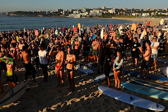 Surfers gathering to paddle out at Bondi Beach to pay tribute to the victims. 