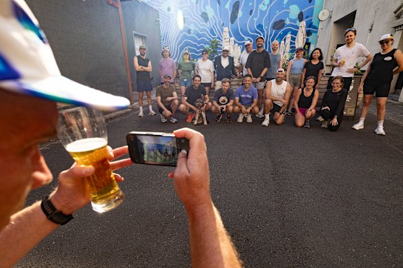 The group’s runners pose for a group shot outside the brewery.