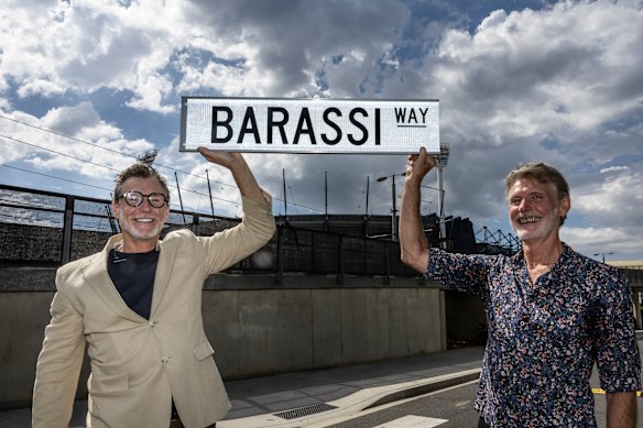 Richard and Ron Barassi jnr hold up a Barassi Way street sign after the announcement that Brunton Avenue will be renamed Barassi way.