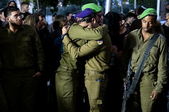 IDF soldiers mourn a colleague killed by Hamas rocket fire in 2024.