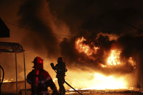 Firefighters at a factory engulfed by wildfire in Uiseong, South Korea, on Saturday.