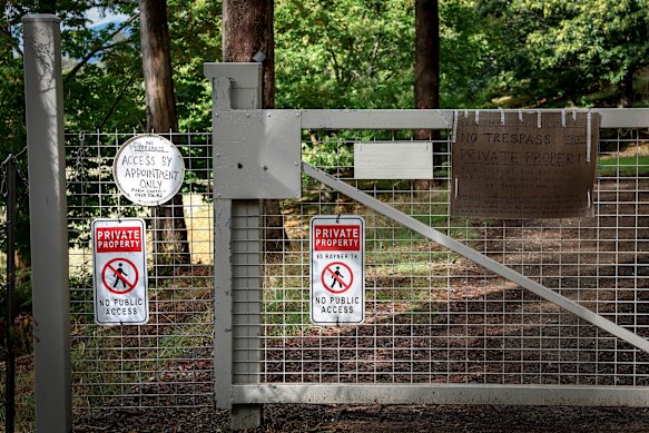 A gate, manned by solar-powered video surveillance, bars access to the property where Dezi Freeman shot dead two police officers in August.