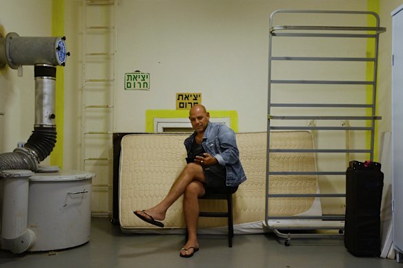 A man waits inside a bomb shelter during air raid in Tel Aviv on Tuesday.