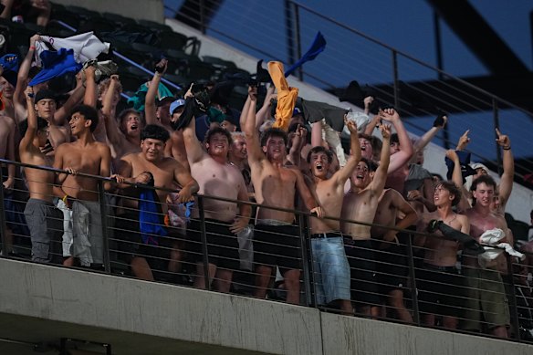 Spectators react during the seventh inning of a baseball game between the Texas Rangers and the Los Angeles Angels, Tuesday, July 7, 2026, in Arlington, Texas.