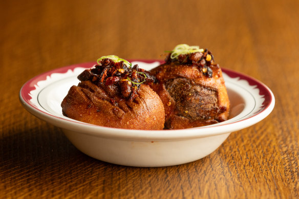Dim sims the size of baseballs are served with chilli crisp at The Punters Club.