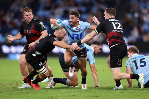 Jake Gordon chasing a spread  for the Waratahs successful  Super Rugby.