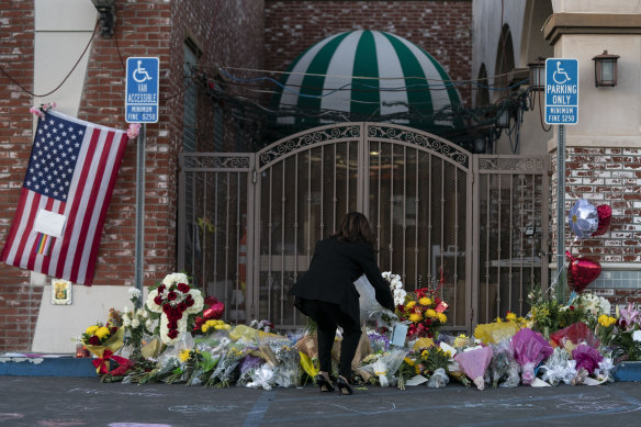 US Vice President Kamala Harris lays flowers at a memorial set up outside Star Dance Studio in Monterey Park, California.