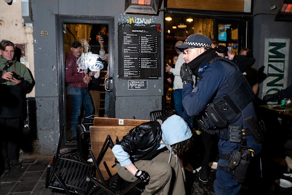 Four people have been arrested after a group descended on an Israeli restaurant in Melbourne on Friday.