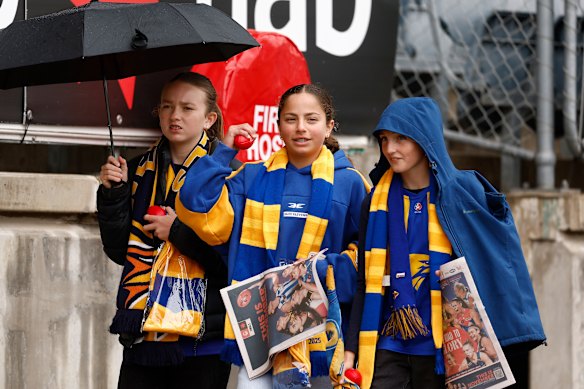 Fans take cover before the AFLW elimination final between Carlton and West Coast. 