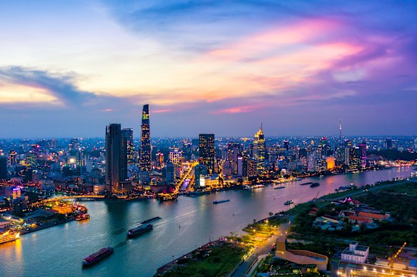 Sunset falls over the burgeoning skyline of Ho Chi Minh City set beside the  Saigon River.