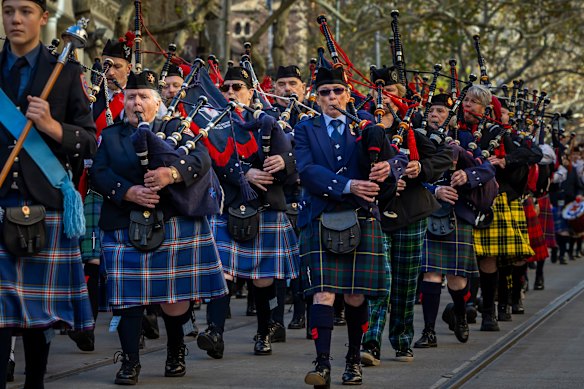Male and female pipers and drummers take part in the 2026 Melbourne Tartan Day Parade along Collins Street on Sunday.